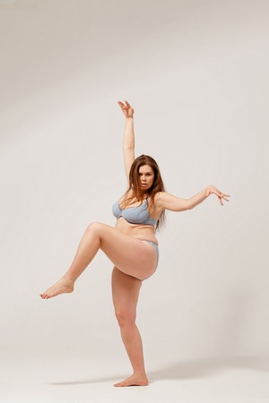 Young overweight female posing on camera in underwear.の写真素材