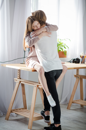 Young people try to catch this happy moment forever. They look sincere and appreciate their love.の写真素材