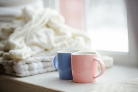 Two cups of different colors resemble different people. Different but very close.の写真素材