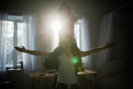 a bautiful lady sits on her boy shoulders and smlies. They look very happy.の写真素材