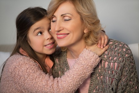 Close up of hugging granny and little granddaughter. Family concept.の写真素材