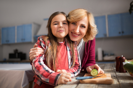 Close up of happy grandmother and granddaughter posing on camera. Family concept.の写真素材