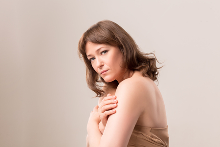 Charming model standing half turn and posing on camera. Professional shooting. Mid age woman over 35 years old concept.の写真素材