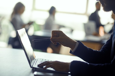 Working people on laptops in office. Preparing reports about finished project. Business conept.の写真素材