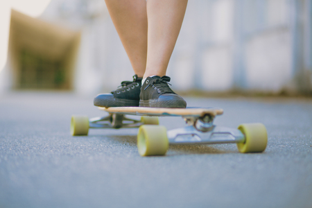 Awesome legs on the skateboard. Black sneakers. Skating inthe parkの写真素材