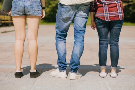 Great legs. Girls in shorts and jeans. Guy wearing white sneakers.の写真素材