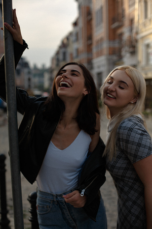 Lesbian couple walking in the city and making selfie. Wearing fashion clothes. Samesex love concept.の写真素材