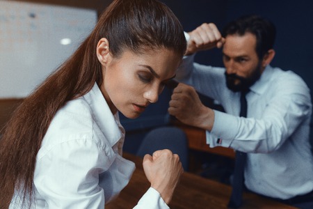 Agressive colleagues dispute while working. Compete in business. Fight of genders concept.の写真素材