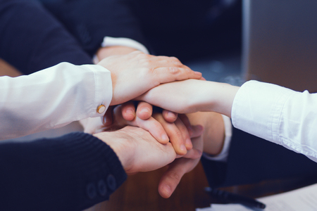 Group Of People In Suits Crossed Hands In Pile. Business Unity Concept.の写真素材