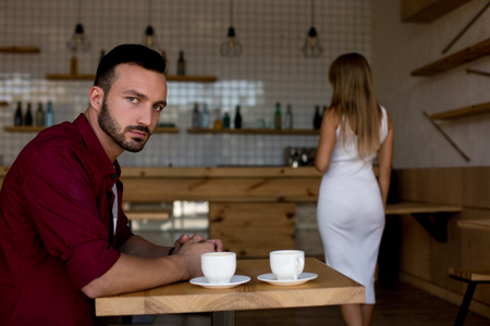 Angry Young Couple In Cafe After Quarrel. Having Troubles In Relations. Love Story Concept.の写真素材