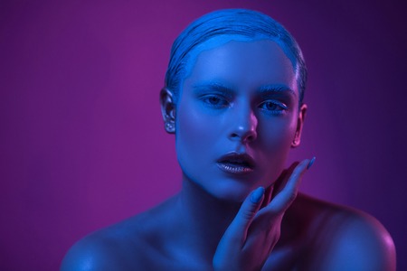 Sexy Opened Lips of High Fashioned Model in Neon Lights. Young woman shows passion and beauty.の写真素材