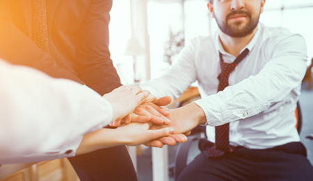 People Crossing Hands Together After Brainstorming Meeting In Office.Selective Focus On Hands. Business Concept.の写真素材