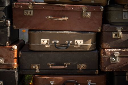Stack of aged suitcases stacked in a heap. Traveling concept. Backgroundの写真素材