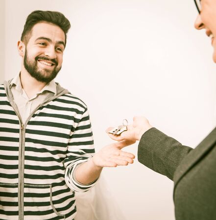 Close Up Portrait Of Guy Who Just Rented New Home, Man Are Happy To Receive Keys For Newly Rented Apartment, Toned Imageの写真素材