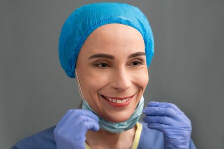 Smiling Woman In Medical Clothes Rejoices At End Of The Coronavirus Epidemic, Caucasian Woman In...