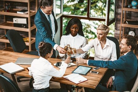 Business People Clinking Glasses Of Champagne, Multi-Ethnic Business Team Celebrating New Project...