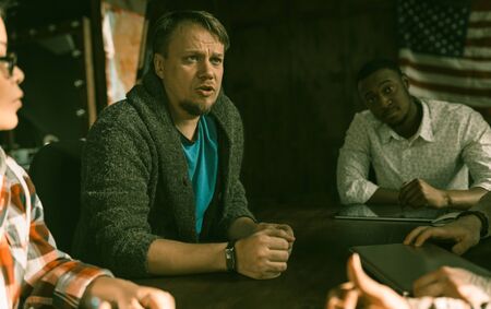 Caucasian Speaker Presents His Concept Of New Business, His Colleagues African Man And Asian Woman...
