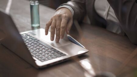 Close-up shot of a female hand touching a touchscreen, Business woman in formalwear using a computer...