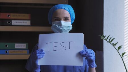 Doctor Holding Paper Blank Test, Female Medical Worker Wearing Blue Uniform Holds Message With Offer...