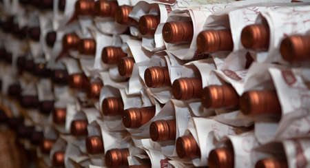 Wine bottles are stored in paper bags at Wine vault. Background or texture of the wine bottles neck with corks. April, 2013. Eger, Hungary.のeditorial素材