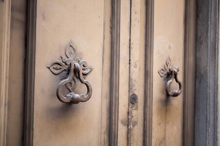 Antique metal handle on front door. Vintage door handles in painted metal. Close up shot.の写真素材