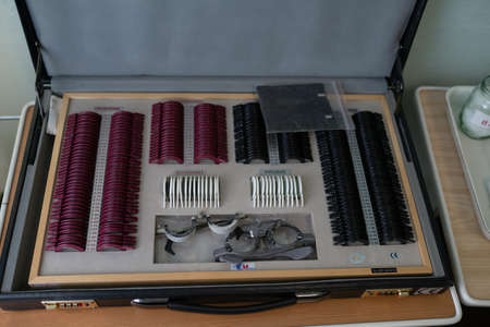 Set of lenses for checking vision in office of an ophthalmologist. Ophthalmologists suitcase. High...