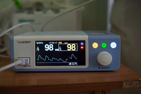 Medical diagnostic equipment. Pulse Oximeter, Lucon Mediana brand. Device to measure heart rate and oxygen saturation in blood. Close up shot. City Hospital. May, 2020, Brovary, Ukraine.のeditorial素材