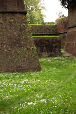 Part of an old fortress in italy. Ancient brick stone wall. High quality photo.