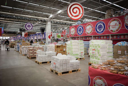 Interior and commodity rows in store of Auchan retail chain during quarantine. March 2020. Kiev,...