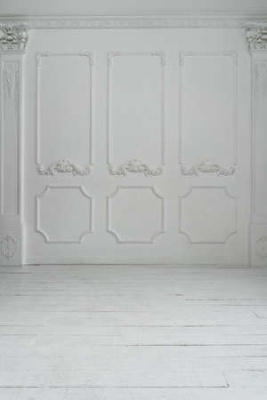Empty white room with stucco decor on wall and wooden flor. Abstract background.の写真素材