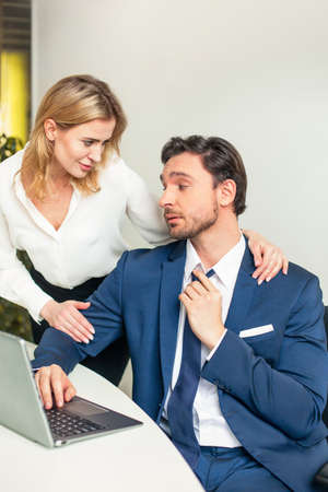 A novel at work. The boss molests his subordinate employee. Sexual harassment. High quality photo