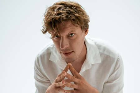 A handsome entrepreneur thinking on ideas with his fingertips with his fingertips preparing a new important step. Confident man freelancer posing isolated on black background.の写真素材