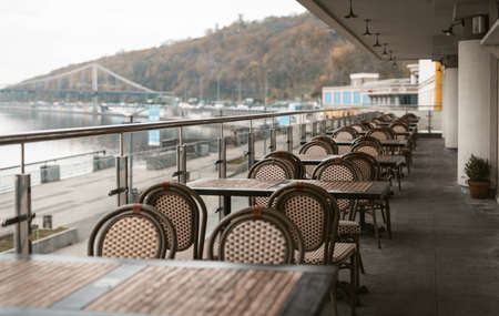 Kyiv, Ukraine, November, 2020. Evening in a empty restaurant with terrace along the Dnipro river coast. Closed on quarantine restaurant. Take away or delivery. High quality photo.のeditorial素材