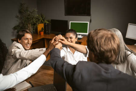 Teamwork. a group of young businessmen came together to create a project. Group handshake of young...