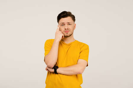 Confusion or disappointment, facepalm handsome young man on his face. Young casual man in yellow...