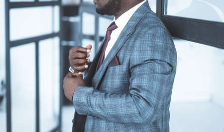 Handsome Male in Formal Plaid Suit in his Fashionable Modern Office. Business center. Close-up. Windows background. High quality photoの写真素材