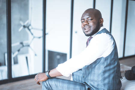 Cute Guy in Formal Attire Looking Back Over his Shoulder and Enjoying his Office. Close-up. High quality photoの写真素材