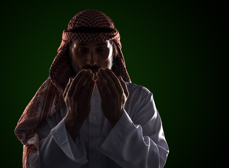 Arab man in prayer with his palms in front of his face. It conveys the devotion and spirituality inherent in Islamic culture. High quality photoの写真素材