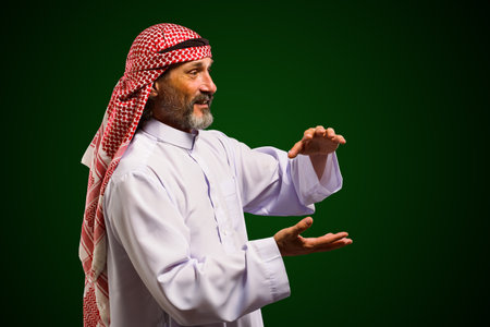 Arab sorcerer forming energy ball with his hands, performs mystical ritual. Mystical and supernatural aspects of traditional Arab spiritual practices. High quality photoの写真素材