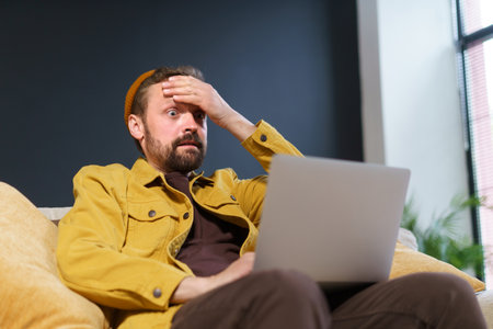Shocked users reaction to online content he discovered on internet. mans expression reflects mix of excitement, surprise, and astonishment comes across something unexpected and thrilling. . High quality photoの写真素材