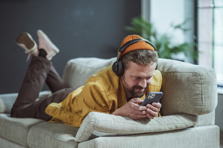Man enjoying his time at home. The image portrays a sense of relaxation and tranquility as the man...