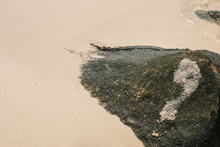 Rock with Painted Question Mark on Tranquil Beach