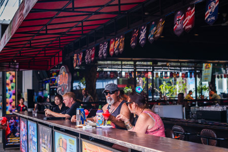Patrons Relaxing at a Covered Counter with Red Awning