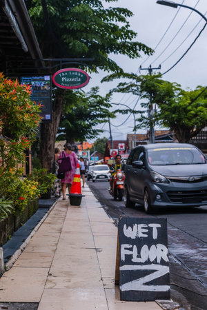 Wet Floor Sign on Busy City Sidewalkのeditorial素材