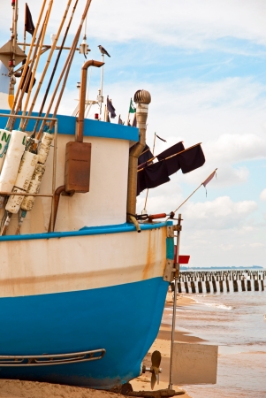 Blue fishing boat on the Baltic seashoreの写真素材