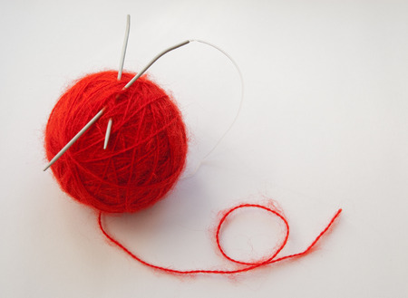 Red mohair wool and knitting needles