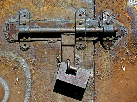 Old metal bolt and padlockの写真素材