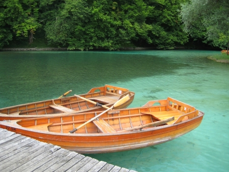 two wooden boats on turquoise lakeの写真素材