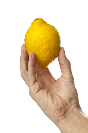 Fresh lemon in handの写真素材