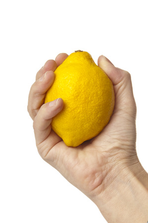 Hand holding a lemonの写真素材